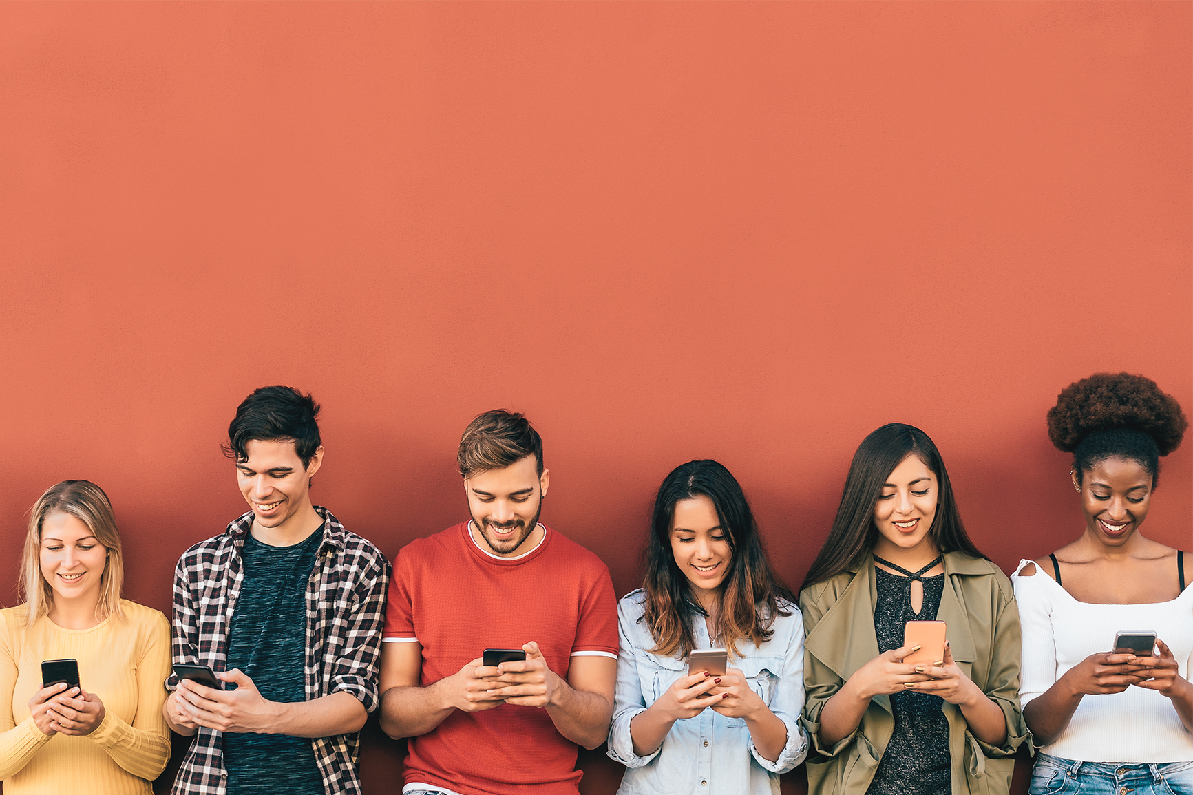 a group of people looking at their phones